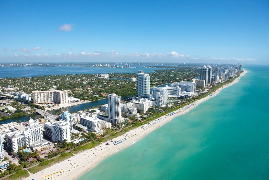 aerial view of city buildings near body of water during daytime