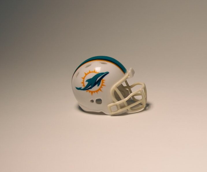 a football helmet sitting on top of a white table