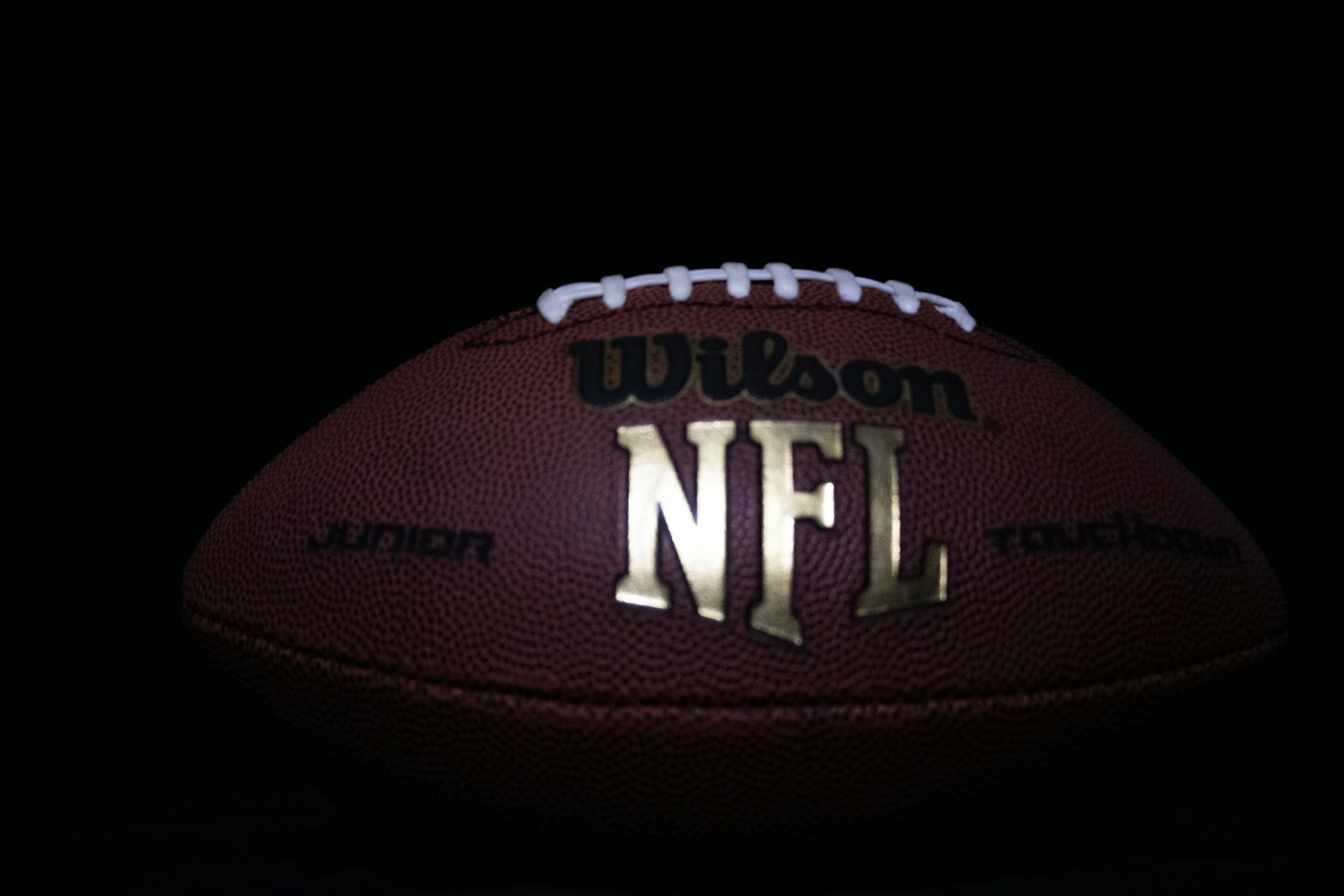 a close up of a football on a black background